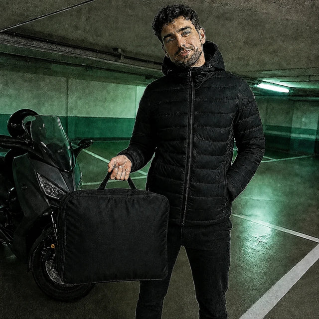 Male customer in a parking lot with his heated Ridge 21 down jacket and QUILLMORE storage bag