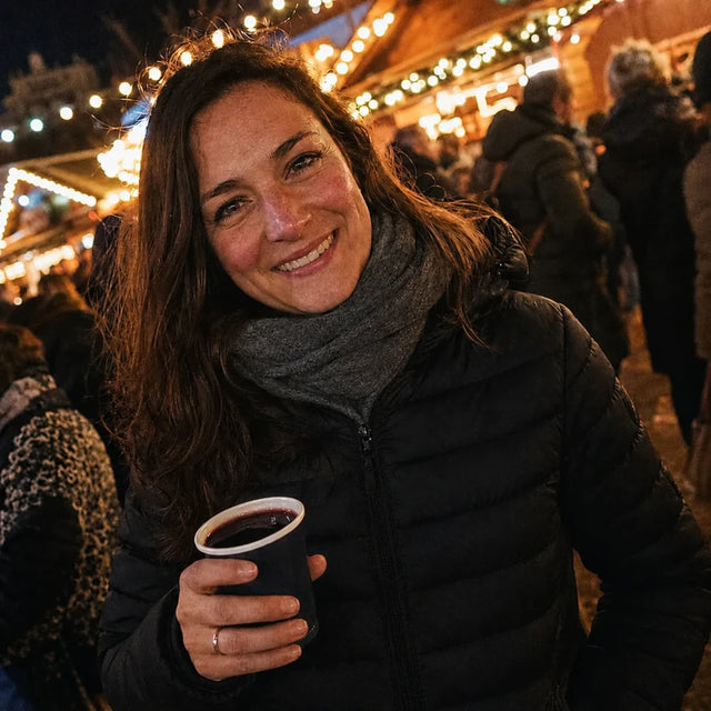 Female customer at a Christmas market in a heated Ridge 21 down jacket
